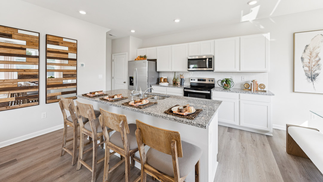 kitchen with stainless steel appliances and four barstools