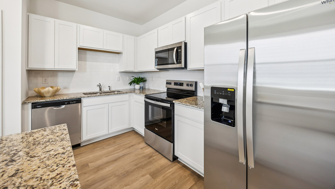 L shaped kitchen with stainless steel appliances
