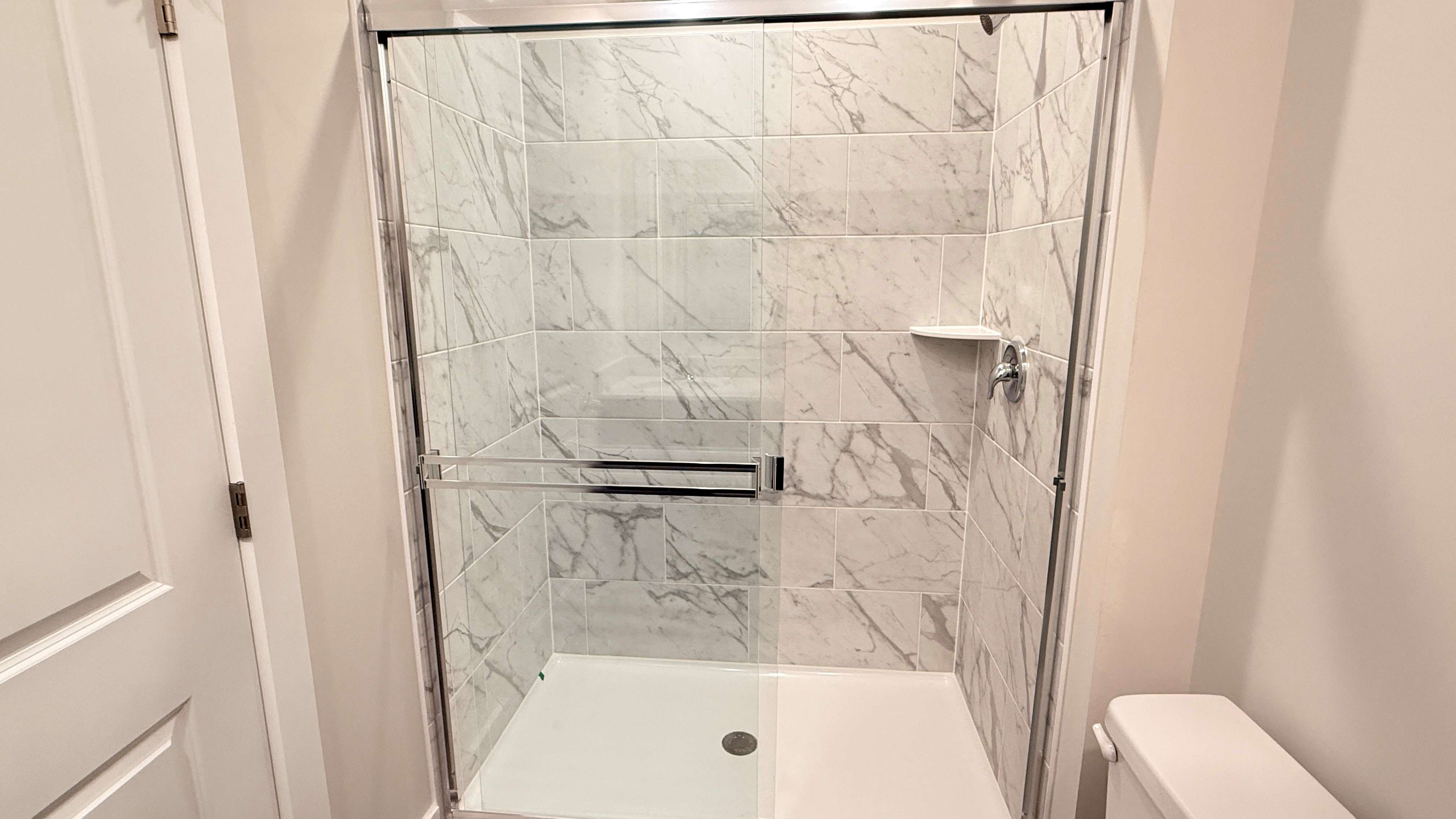 Primary bathroom with tiled walk-in shower