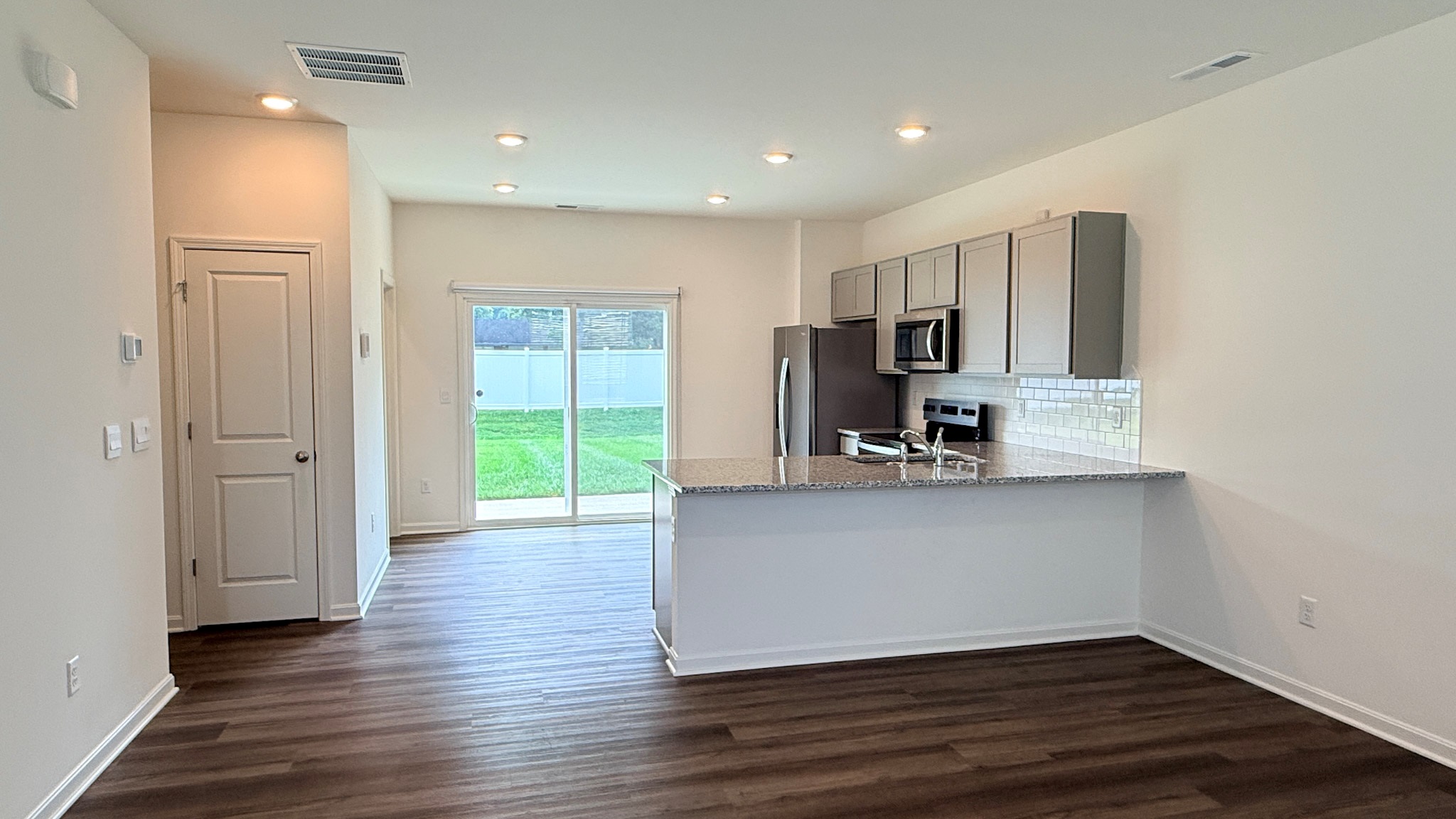 Kitchen with rear sliding glass door.