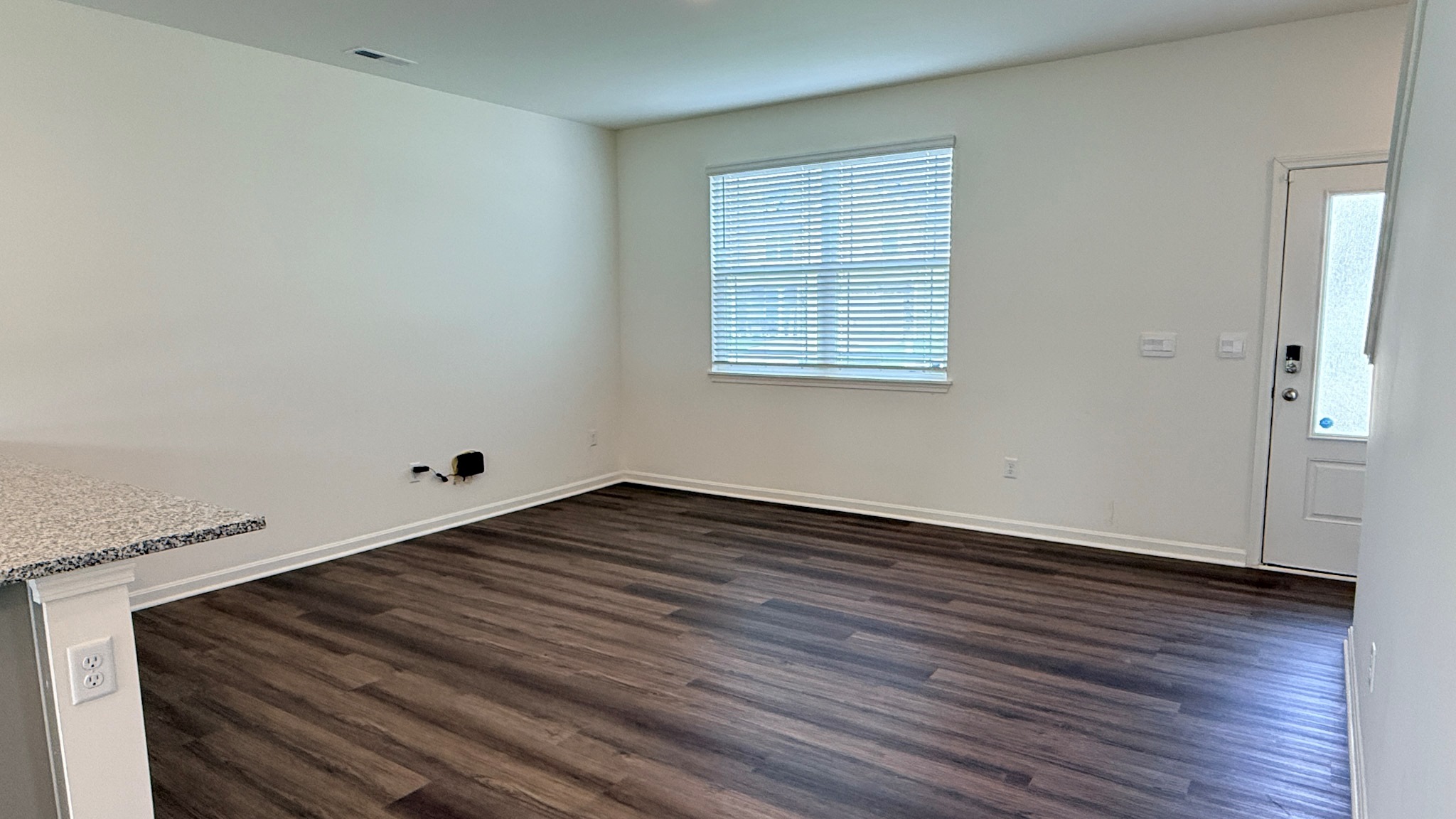 Living room with double window and LVP flooring.