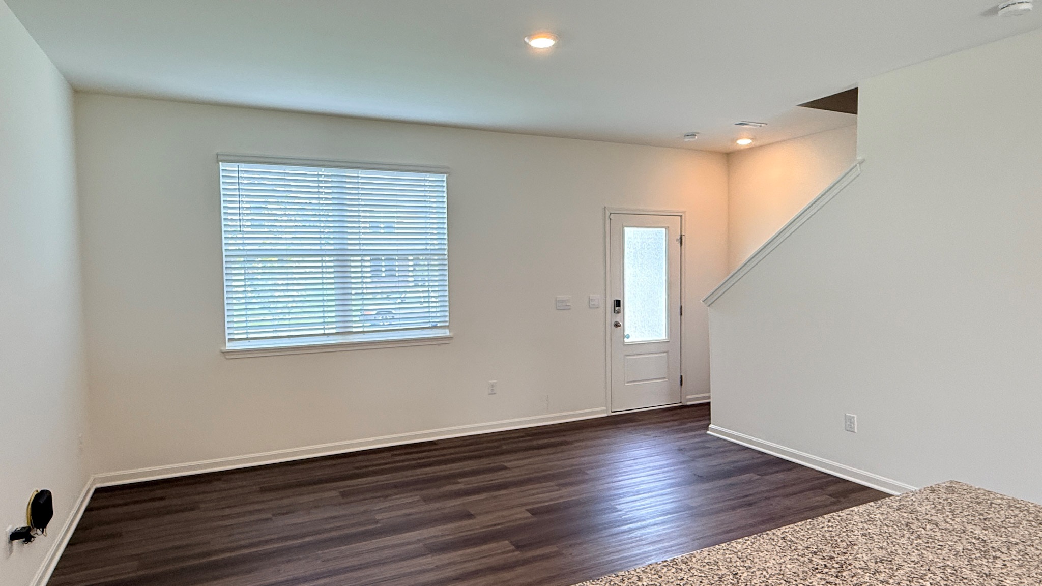 Living room with double window and LVP flooring.