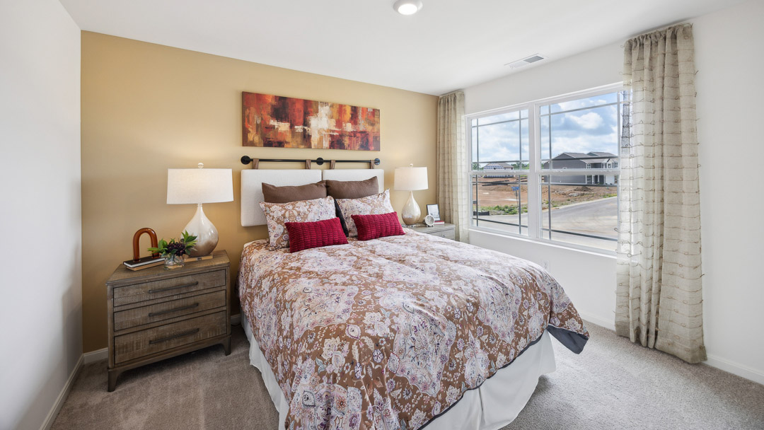 Upstairs spare bedroom with double window, queen bed, 2 nightstands.