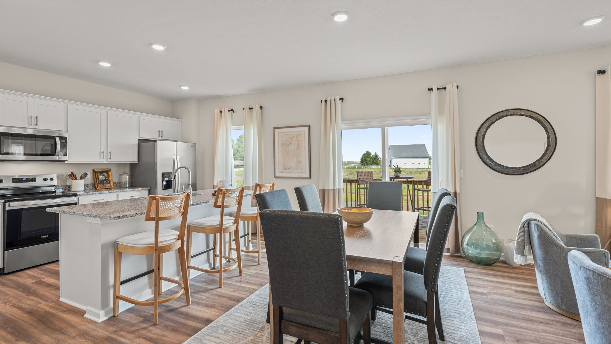 Dining area with rectangular table and six chairs.