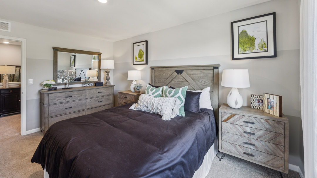 Other view of spare bedroom with bed, 2 nightstands, dresser, and bedroom entry door.