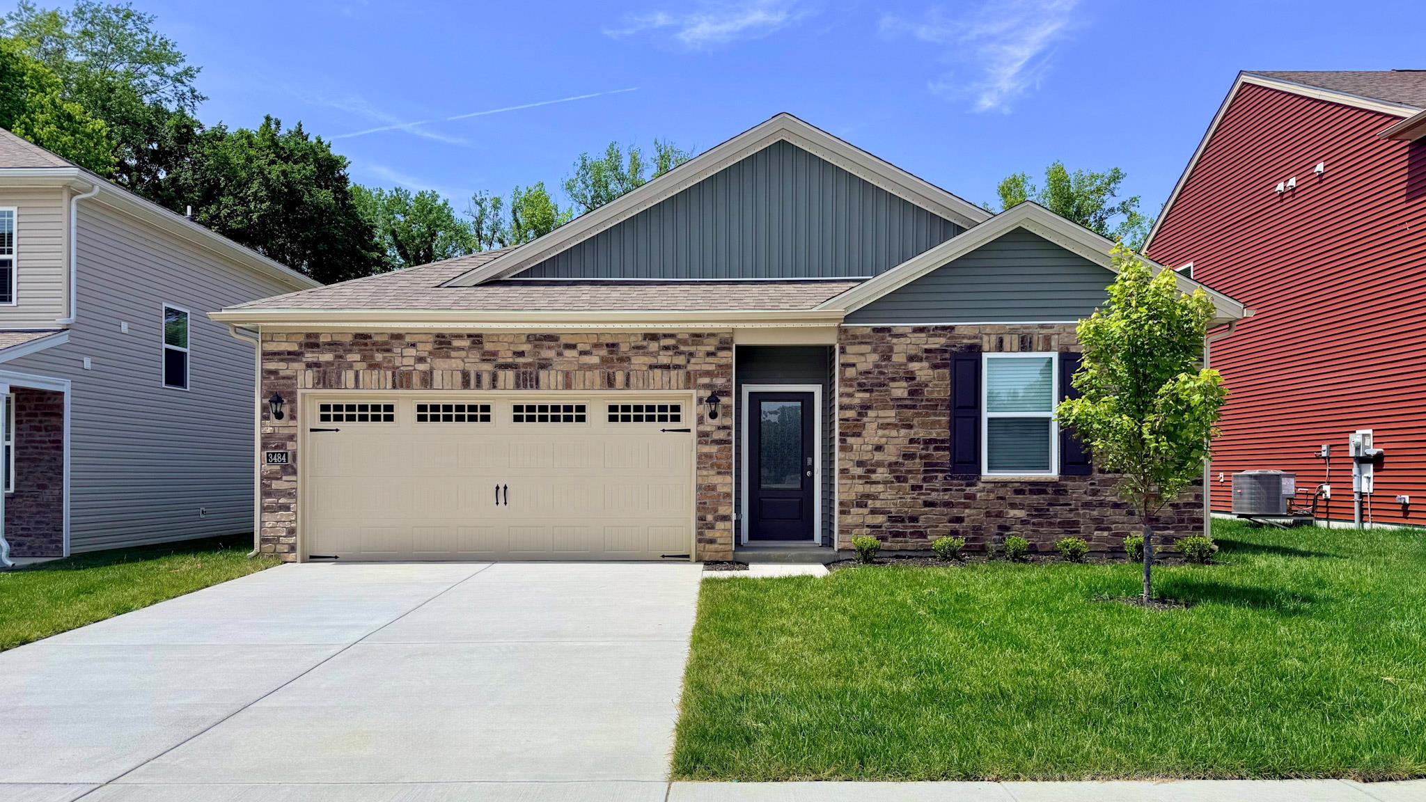 Freeport plan with stone accents, covered stoop, and a two-car attached garage.