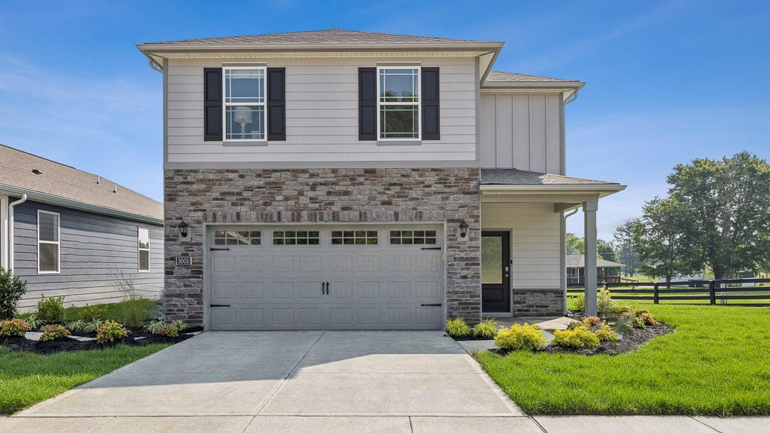 Koehler Woods Pine model home with hardie board siding, stone accents, a covered front porch, and a 2-car attached garage built by D.R. Horton Homes in Koehler Woods of New Albany, Indiana.