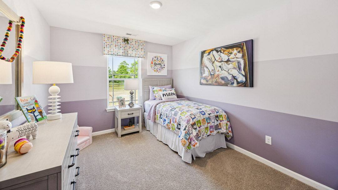 Upstairs purple spare bedroom with twin bed, nightstand, single window, and dresser.