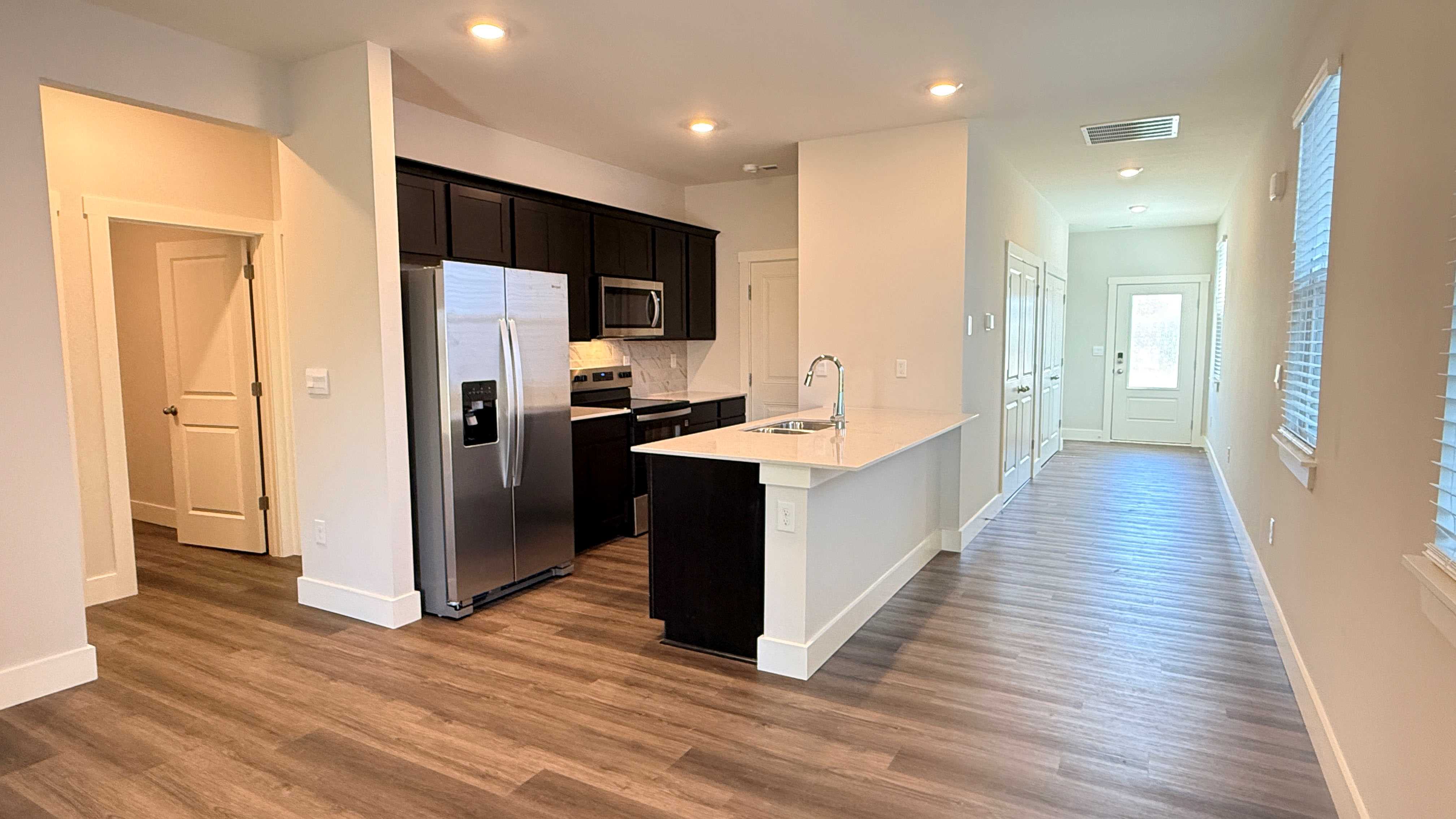 Kitchen with sarsaparilla cabinets and stainless steel appliances.