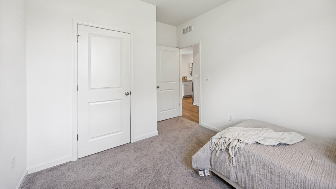 Other view of spare bedroom with closet door and bedroom entry door in view
