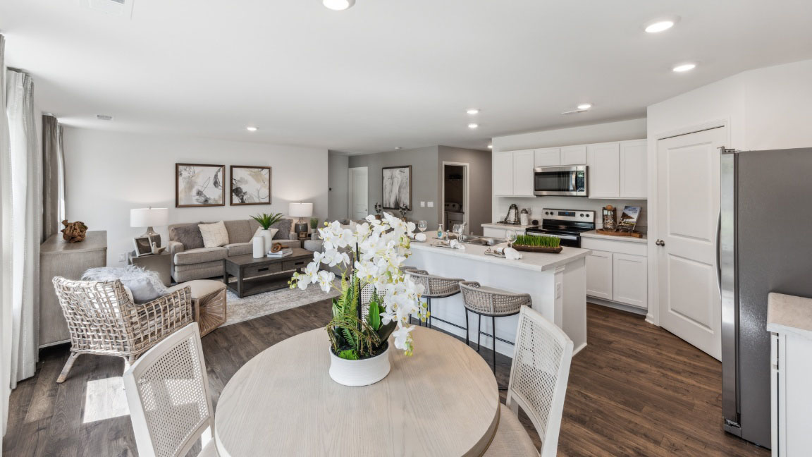 Dining area with round table and chairs.