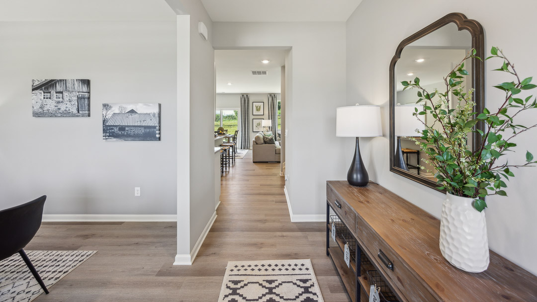 Foyer as you enter the front door with flex room to the left.