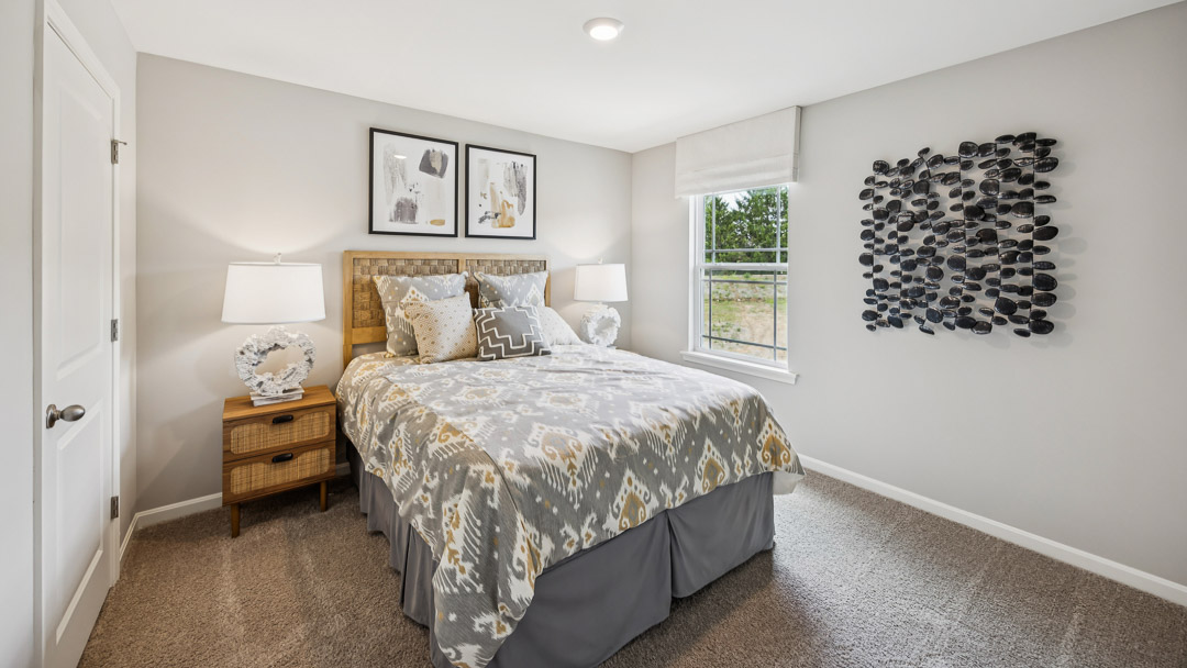 Spared bedroom with bed, nightstands, and single window.