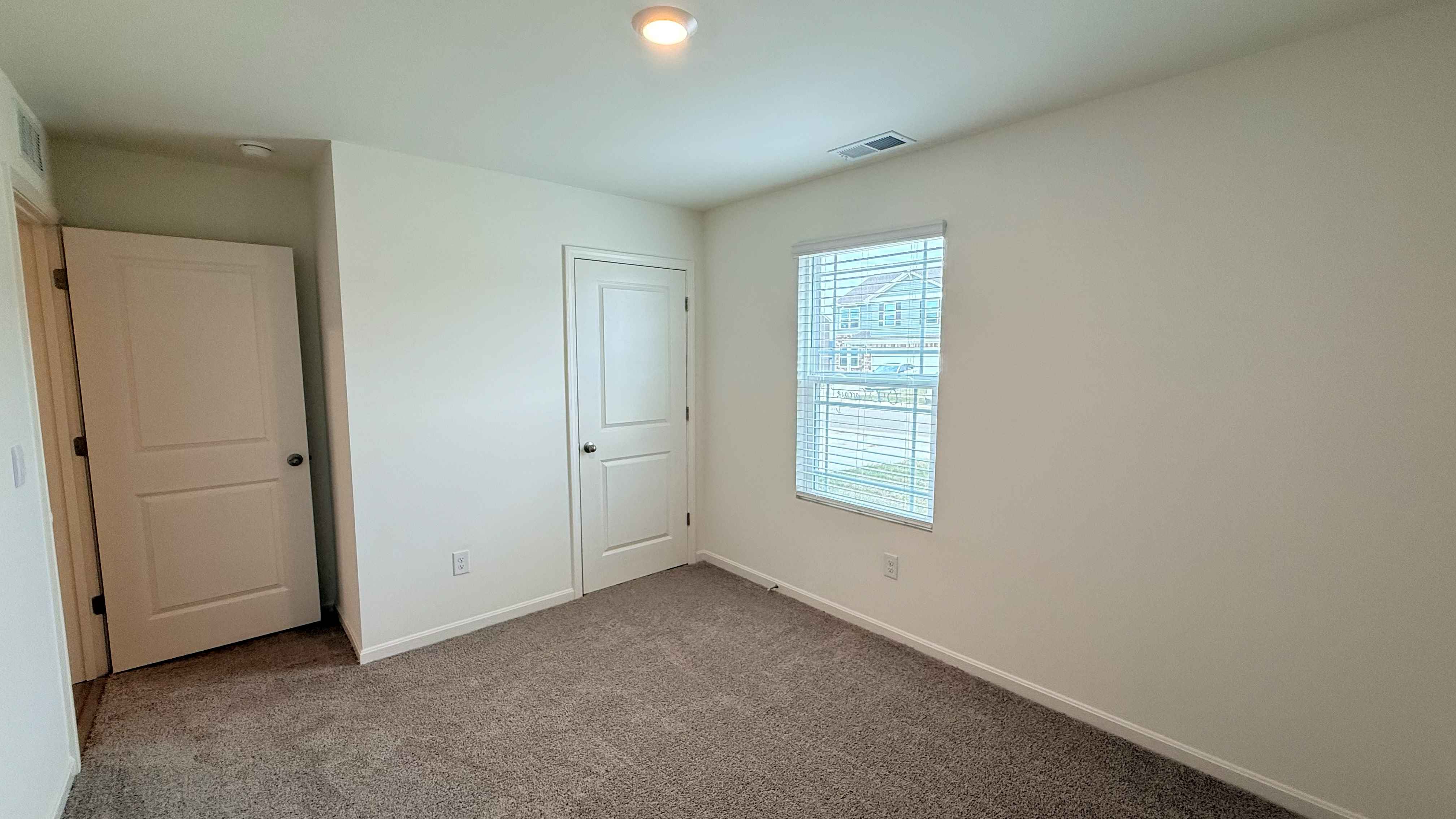 Other view of spare bedroom #2, single window, and closet.