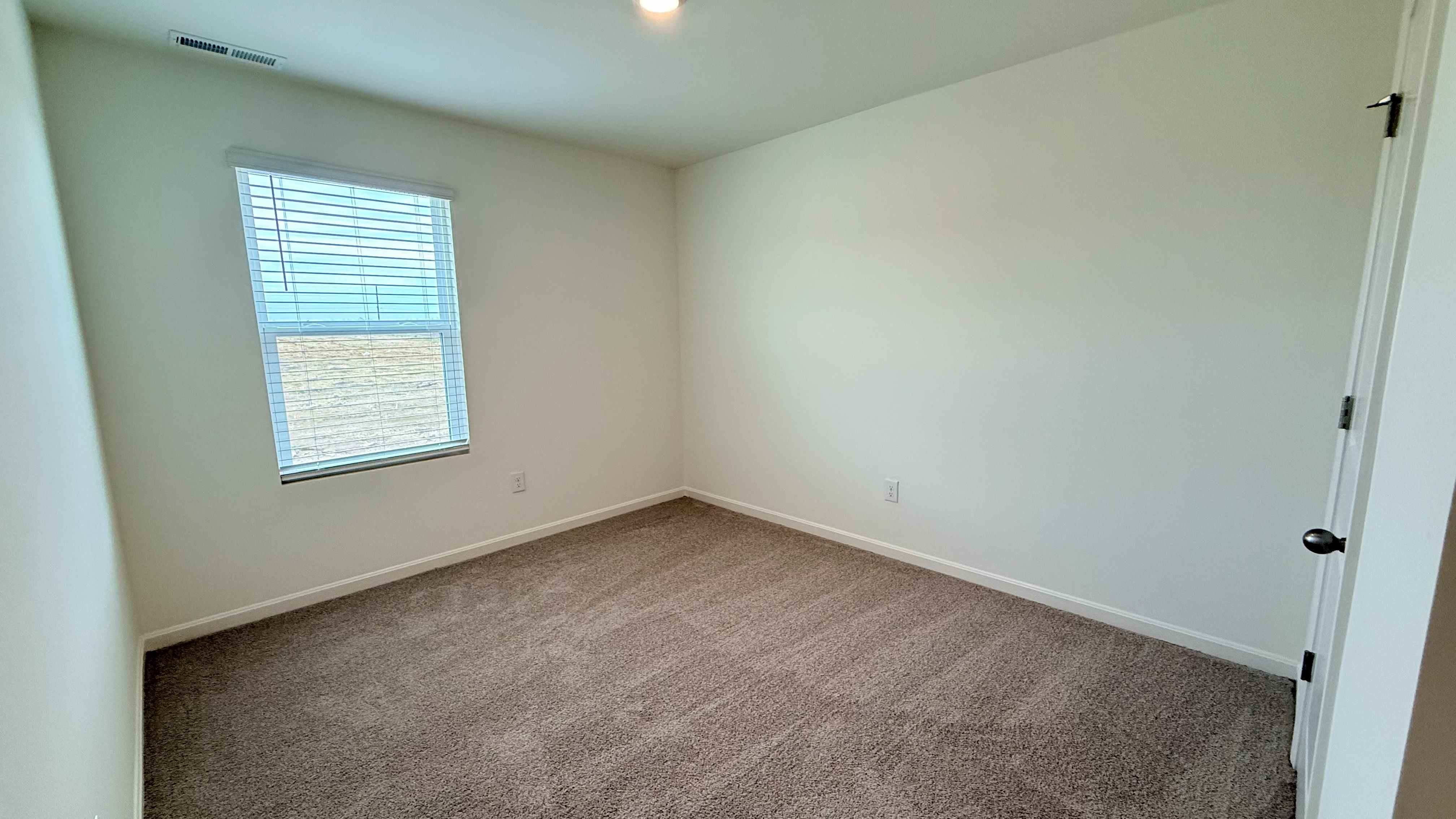 Spare bedroom #3 with single window.
