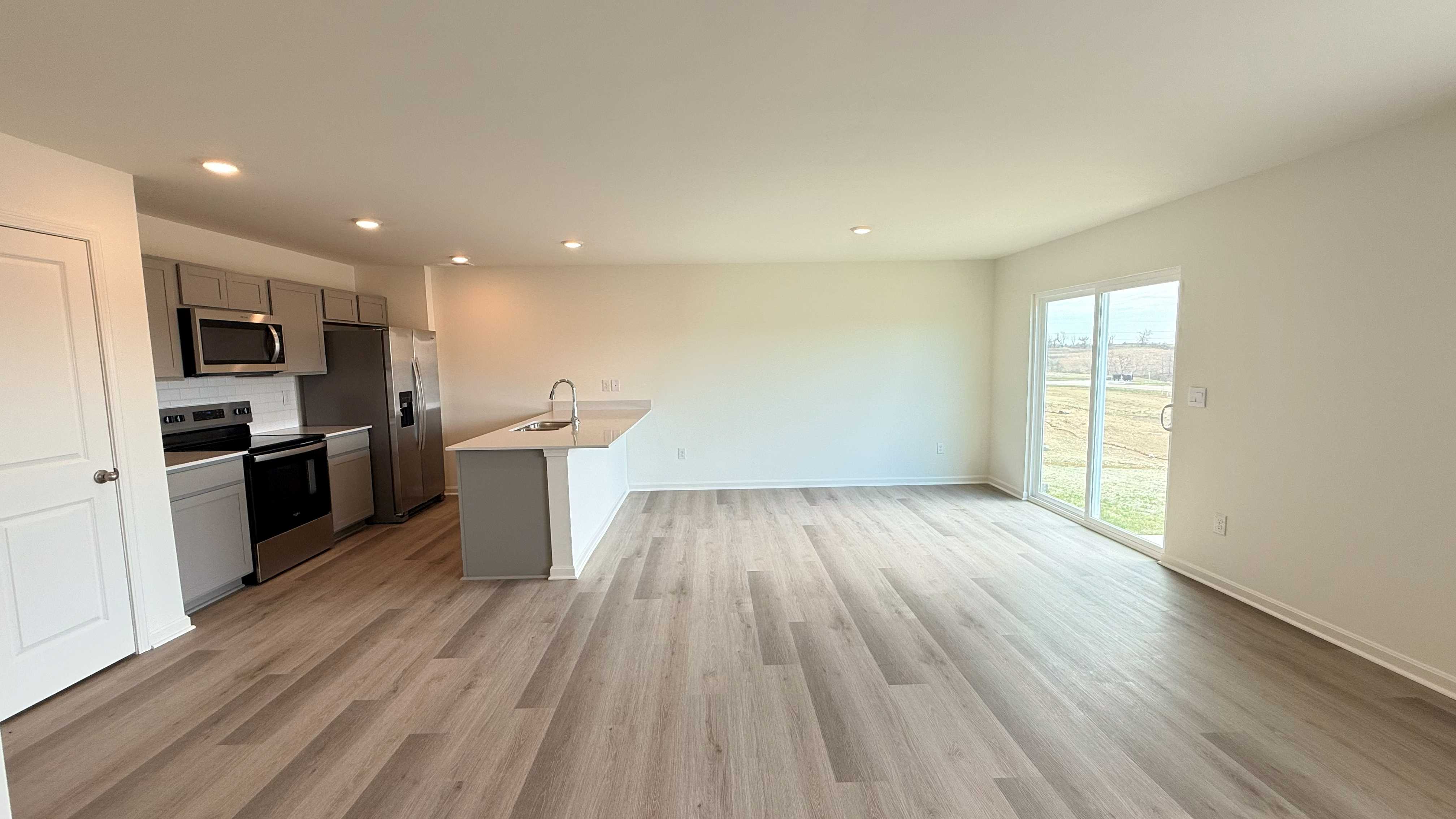 Kitchen and dining area with rear sliding glass door.