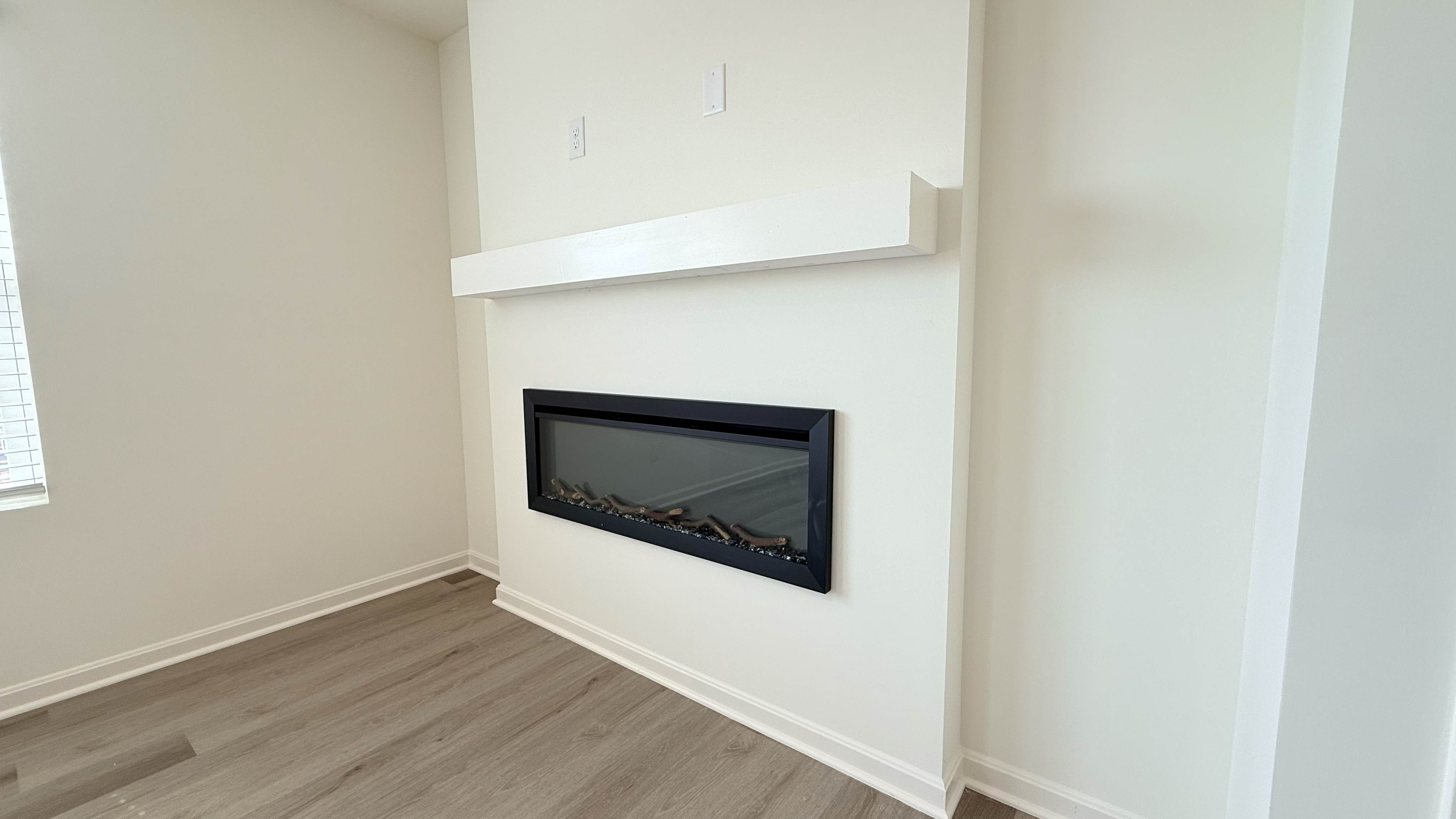 Built-in electric fireplace with remote in the living room.
