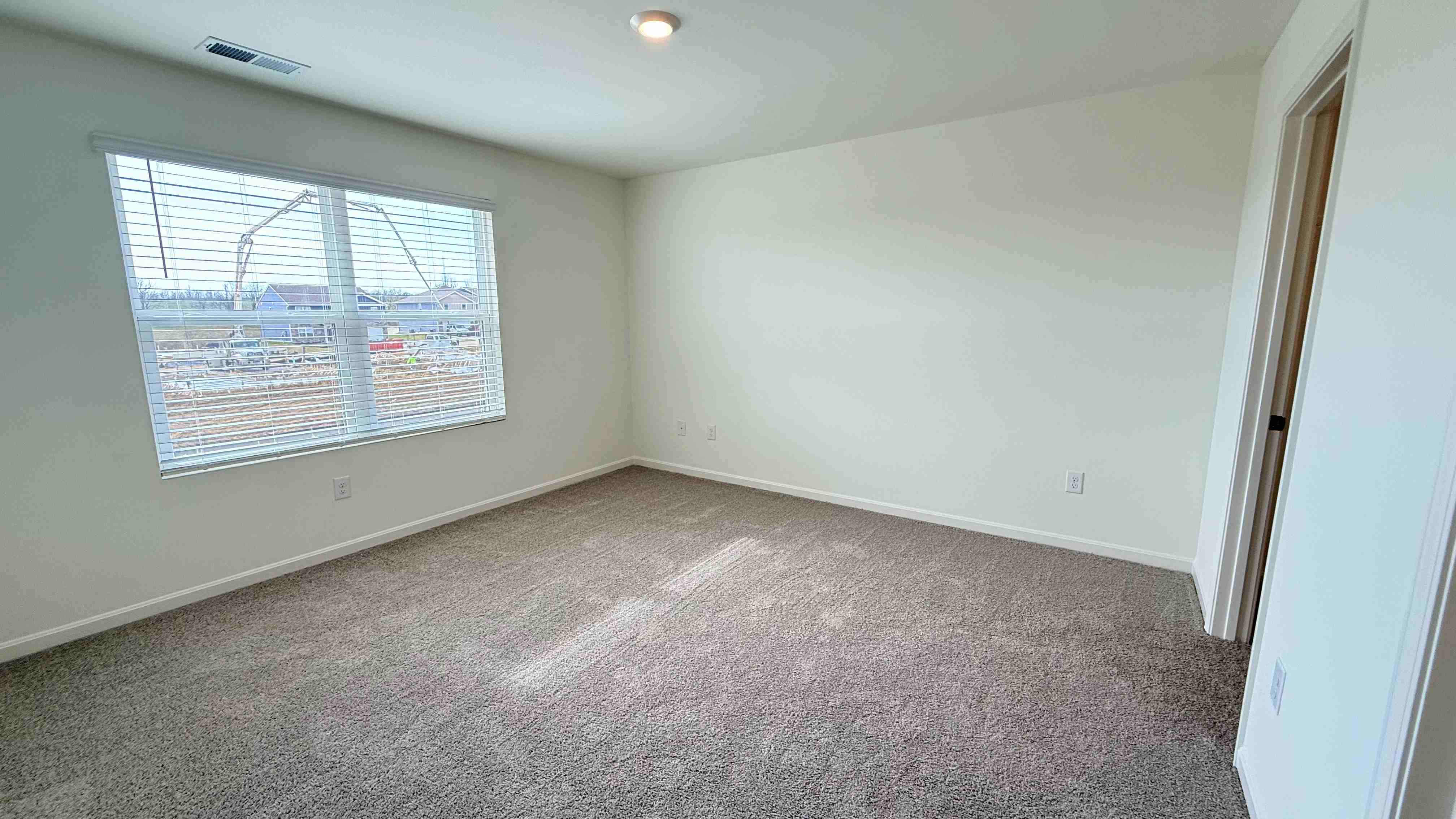 Primary bedroom with double window overlooking the back yard.