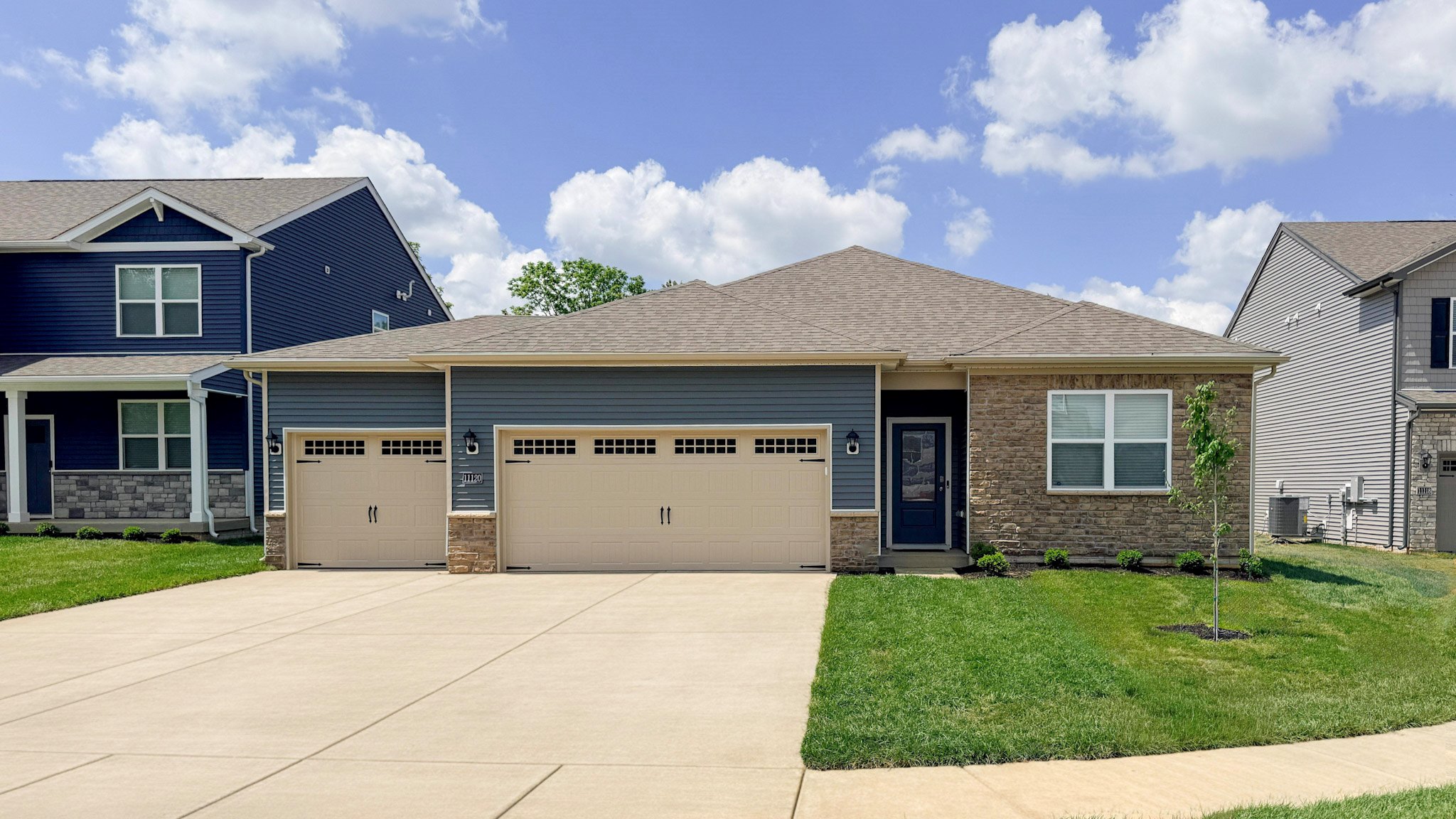 Chatham plan with 3rd car garage, stone accents, and Riverway vinyl siding.