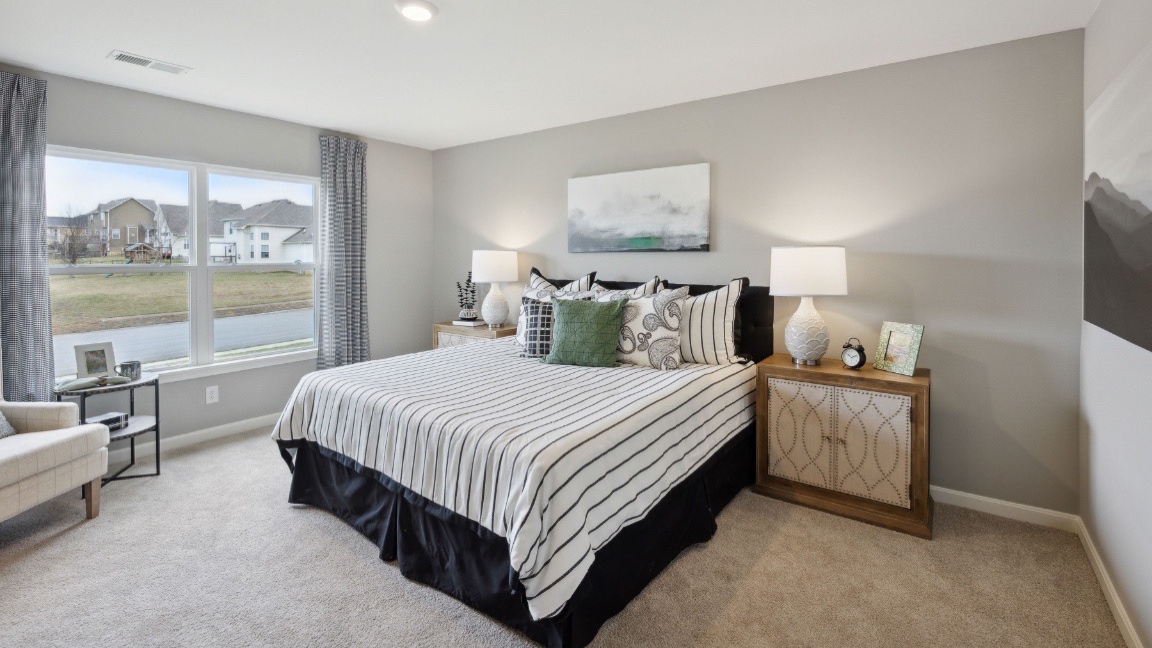 Bedroom with large window for natural lighting.