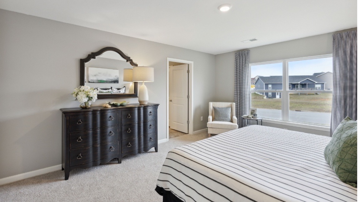 Primary bedroom with large window.
