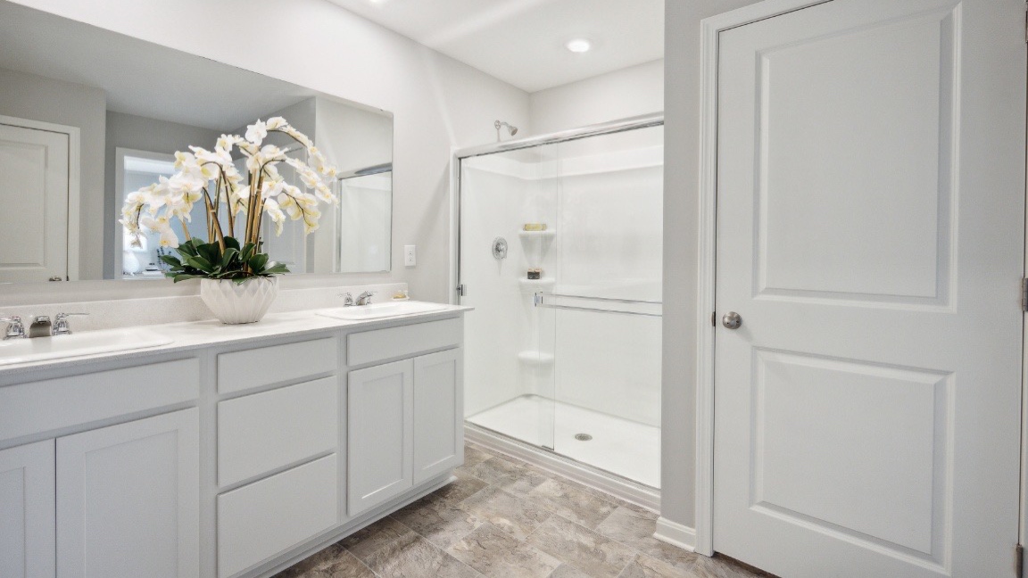 Primary bathroom with tile flooring.