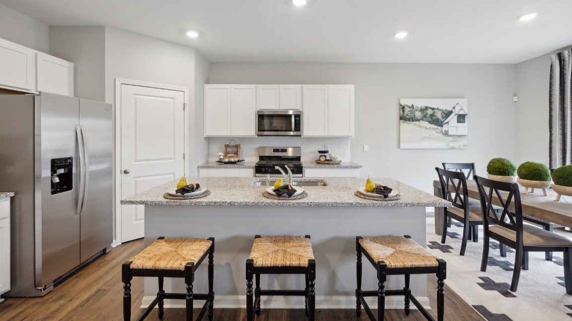 Open concept kitchen with stainless steel appliances.