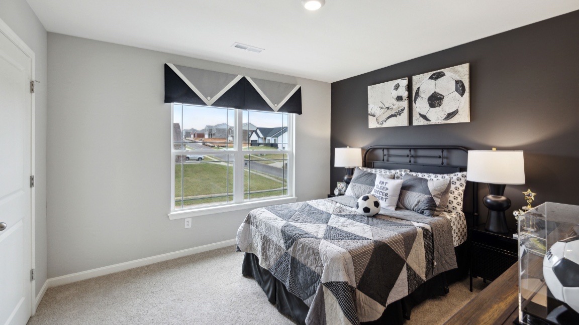 Bedroom with large window and closet.