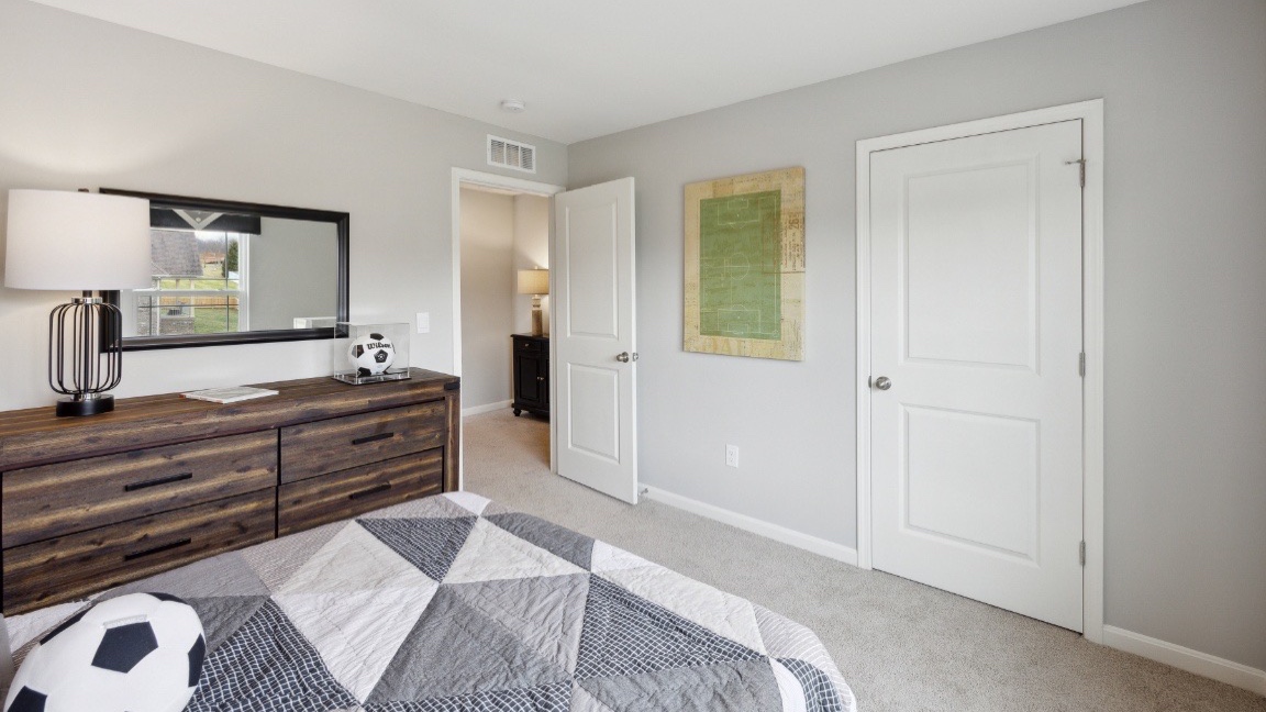 Bedroom with light gray walls.