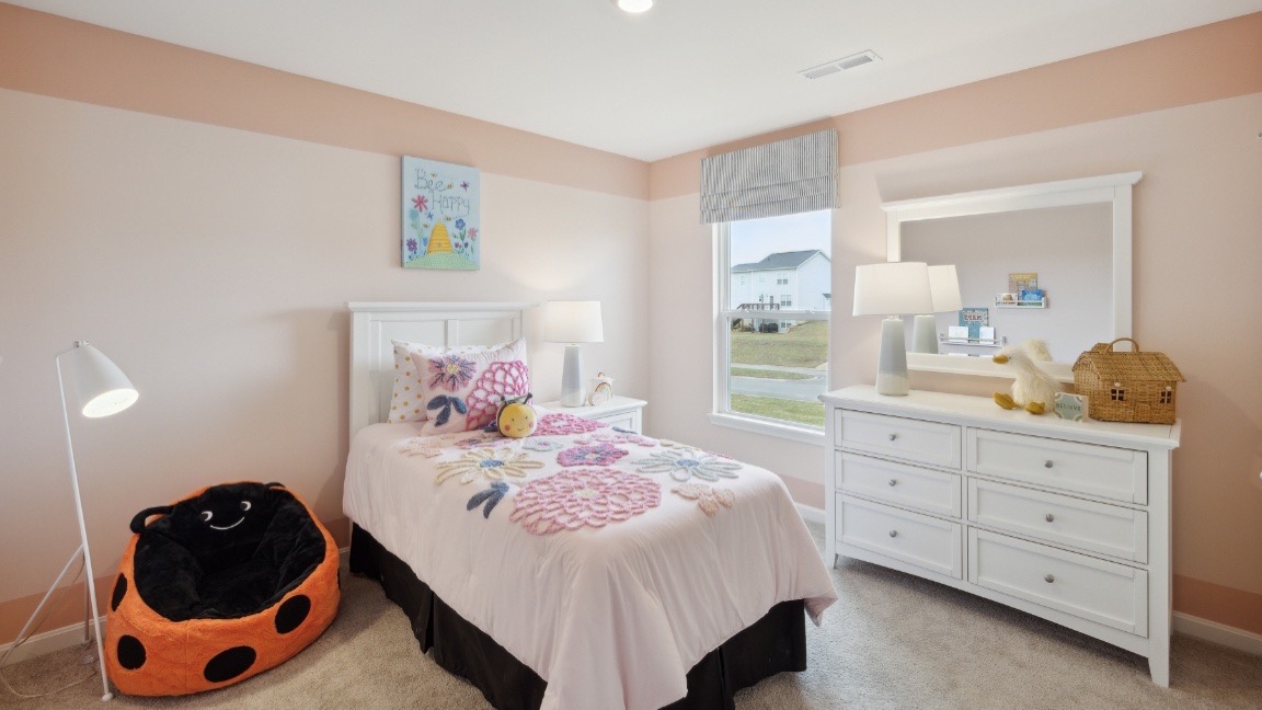 Bedroom with window and carpeted floors.