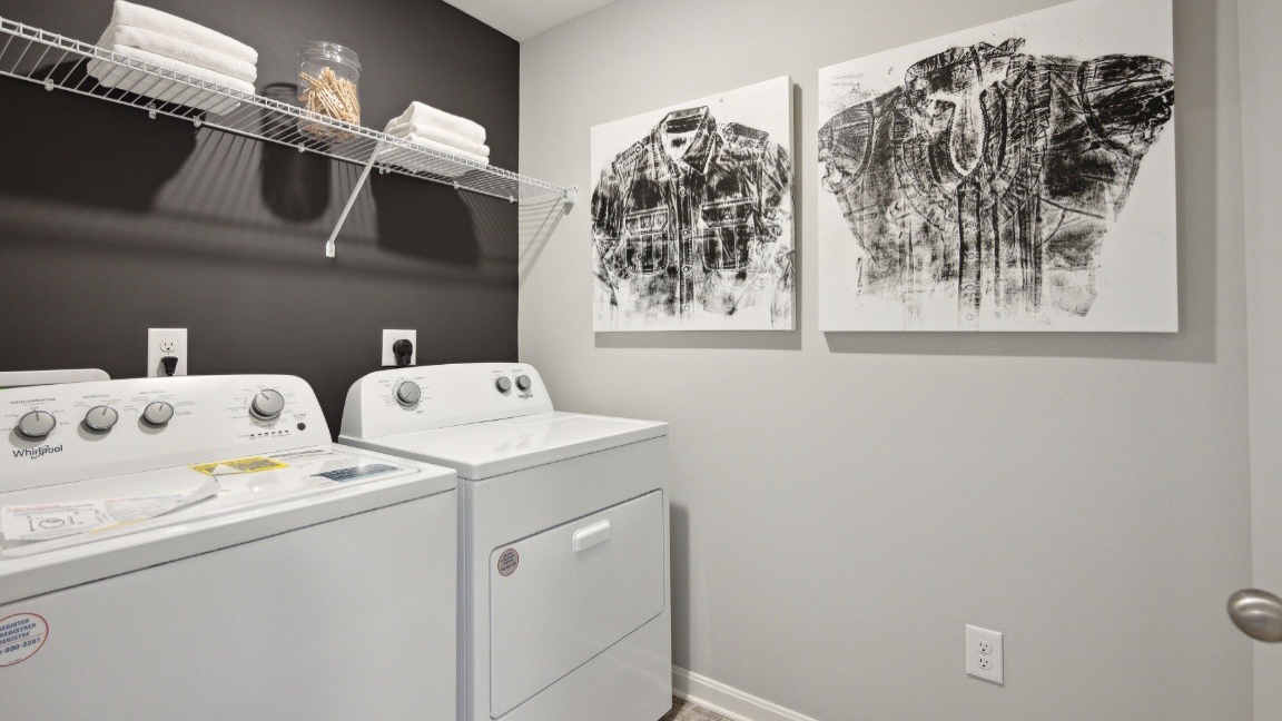 Laundry space with tile flooring.