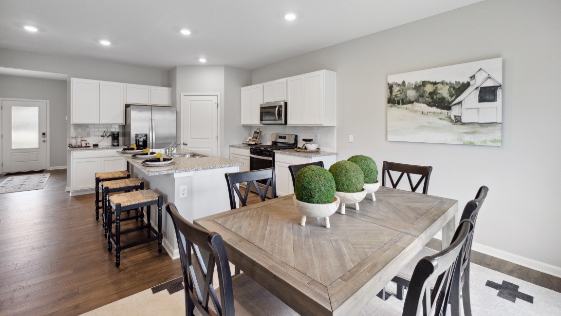 Dining area with large window for natural lighting.