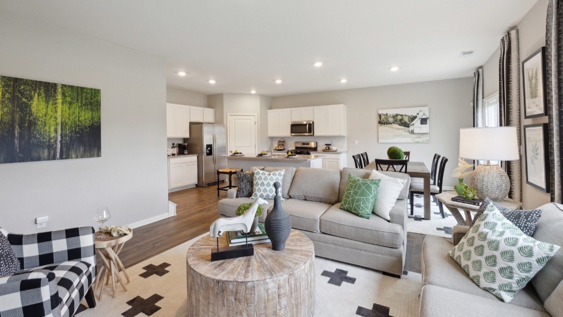 Living room with several windows for natural lighting.