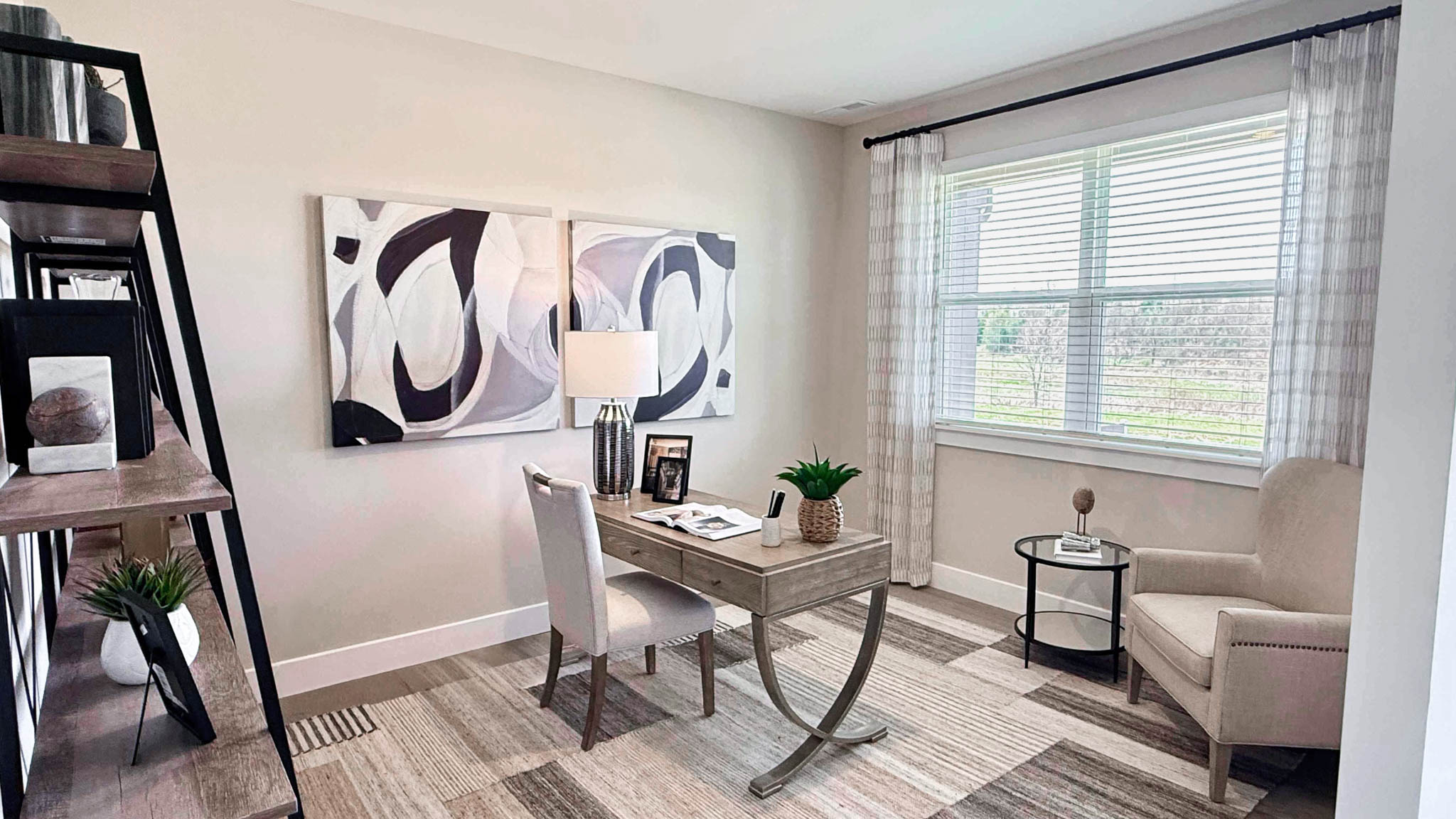 flex room with accent chair and large double window