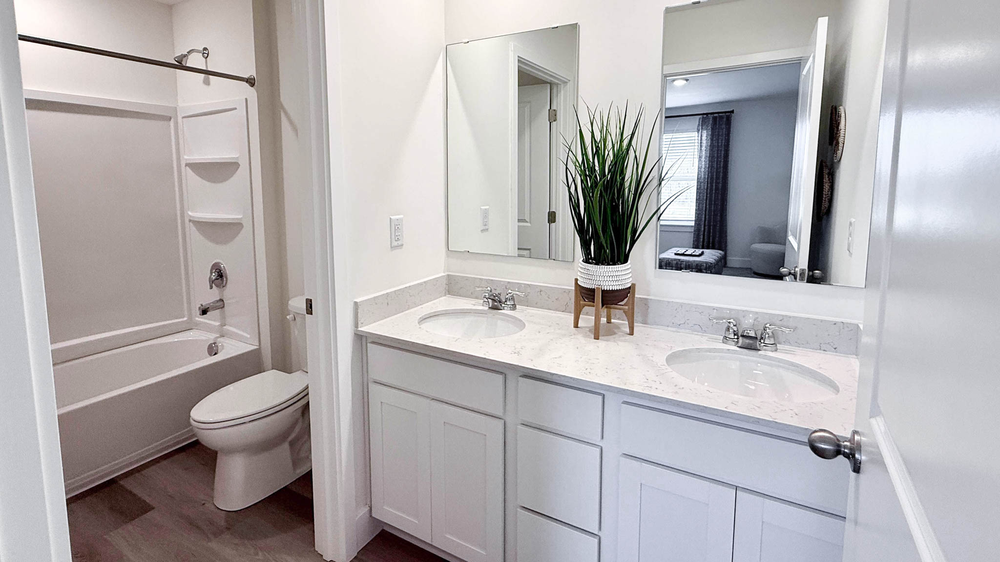 second floor full bathroom with double vanity sink and private water closet