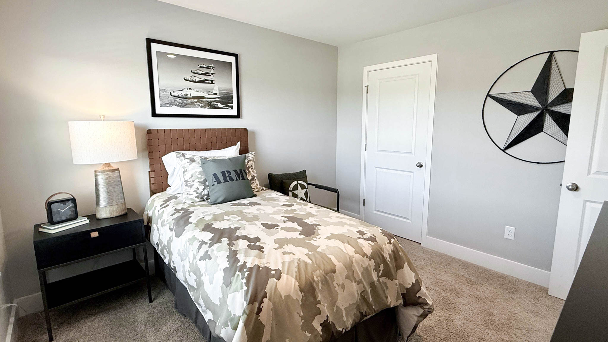 third bedroom with night stand and accent chair