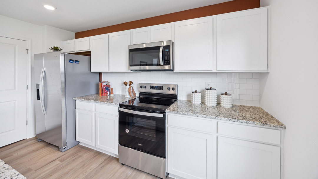 Close up view of kitchen cabinets with solid surface countertops.