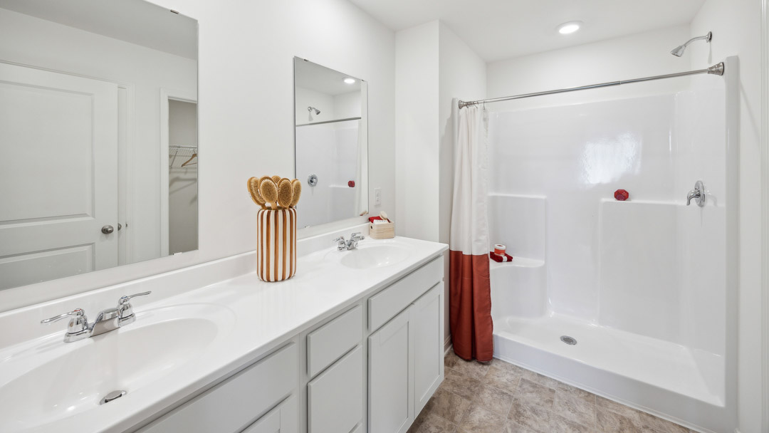 Upstairs primary bathroom with a double bowl vanity, walk-in shower.