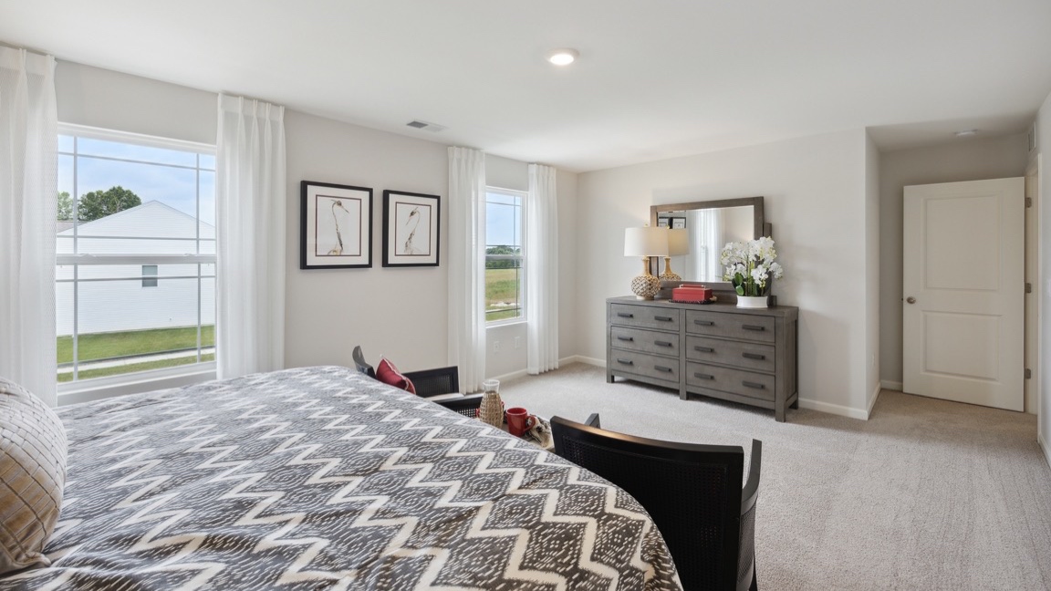 Upstairs bedroom with tv stand, 2 single windows facing front yard