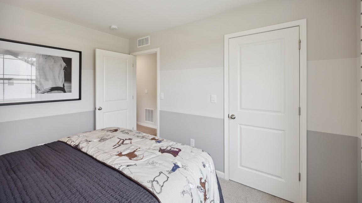 Other view of spare bedroom, closet door, and entry door