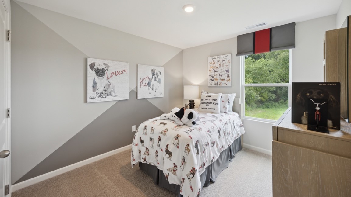 Spare bedroom with bed, single window, and dresser