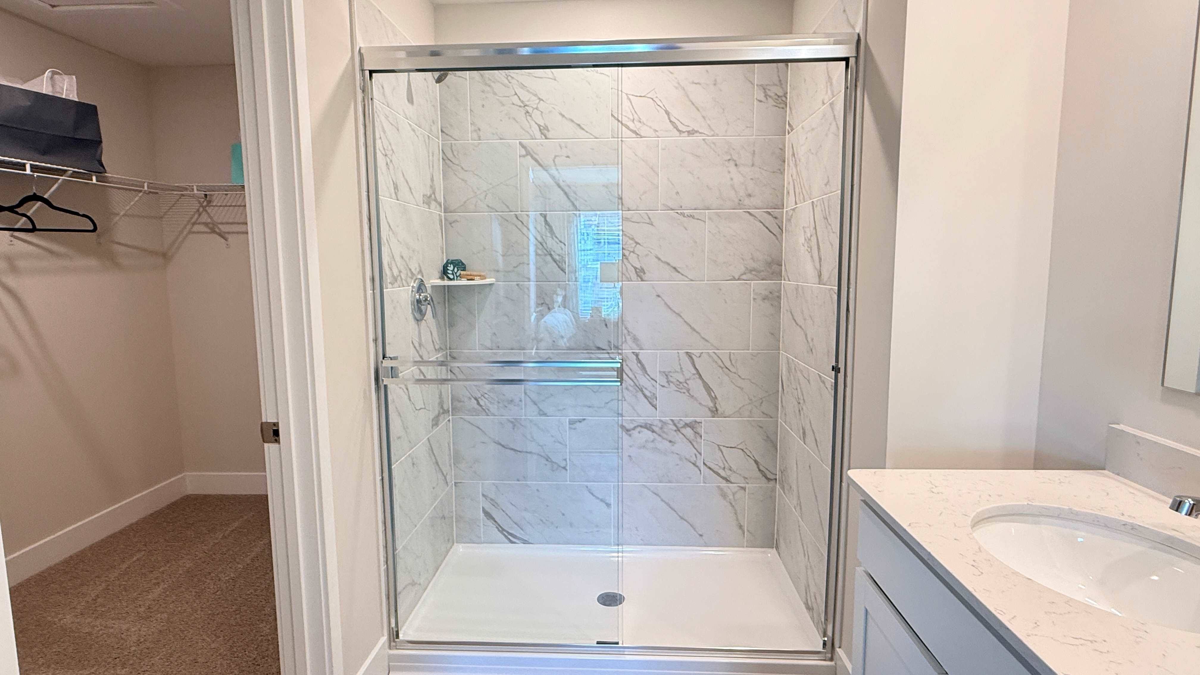Tiled walk-in shower in the primary bathroom