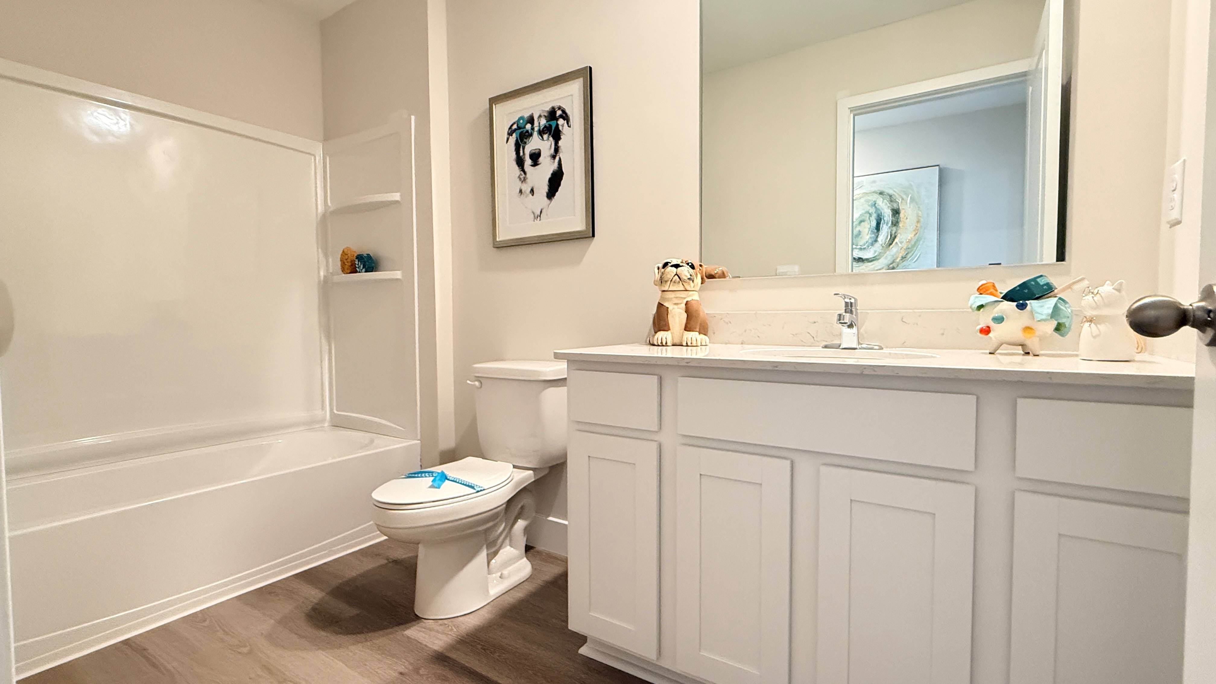 Spare bathroom with vanity, commode, and shower/tub combo unit