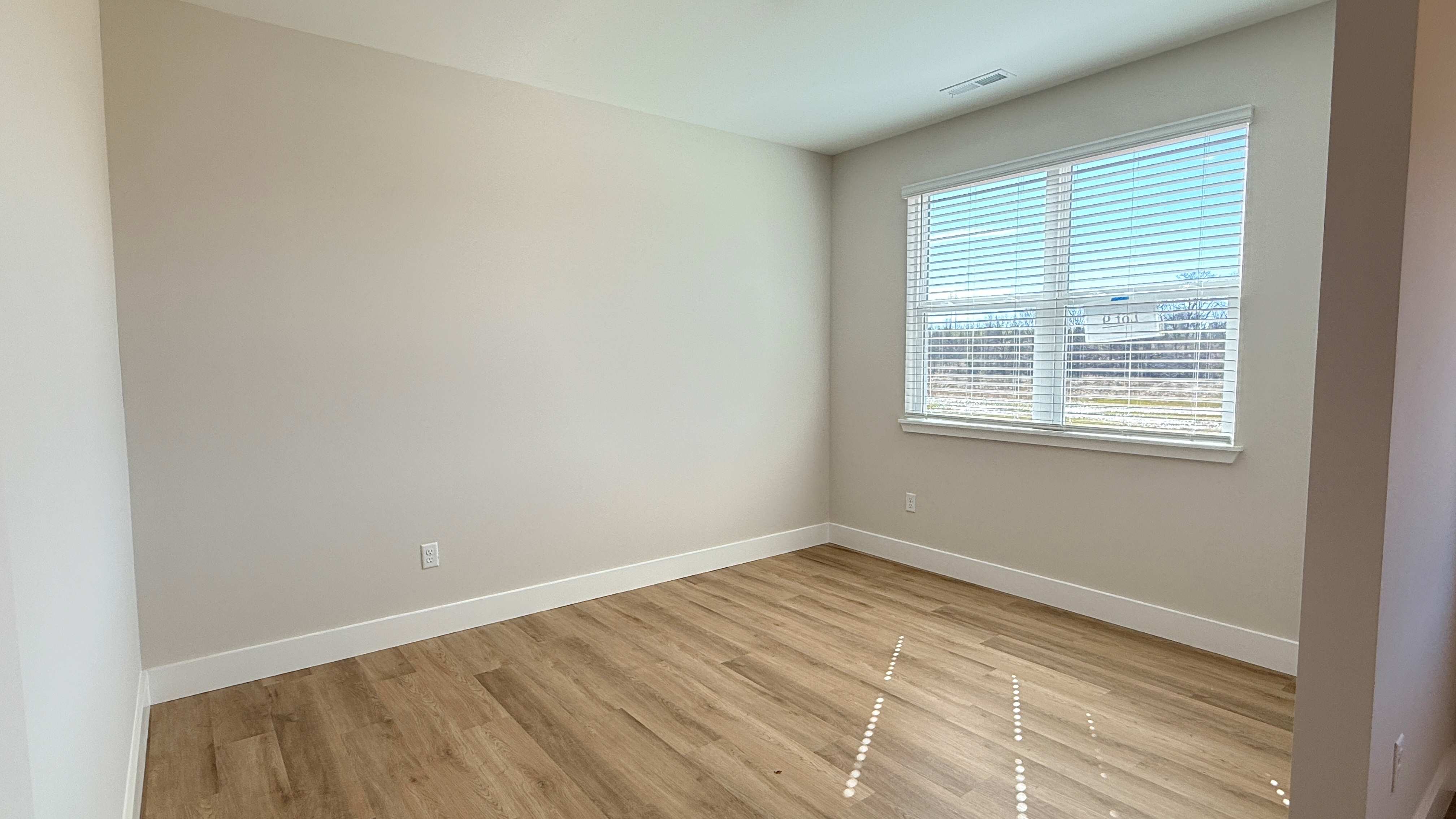 First floor flex room with double window overlooking front yard.