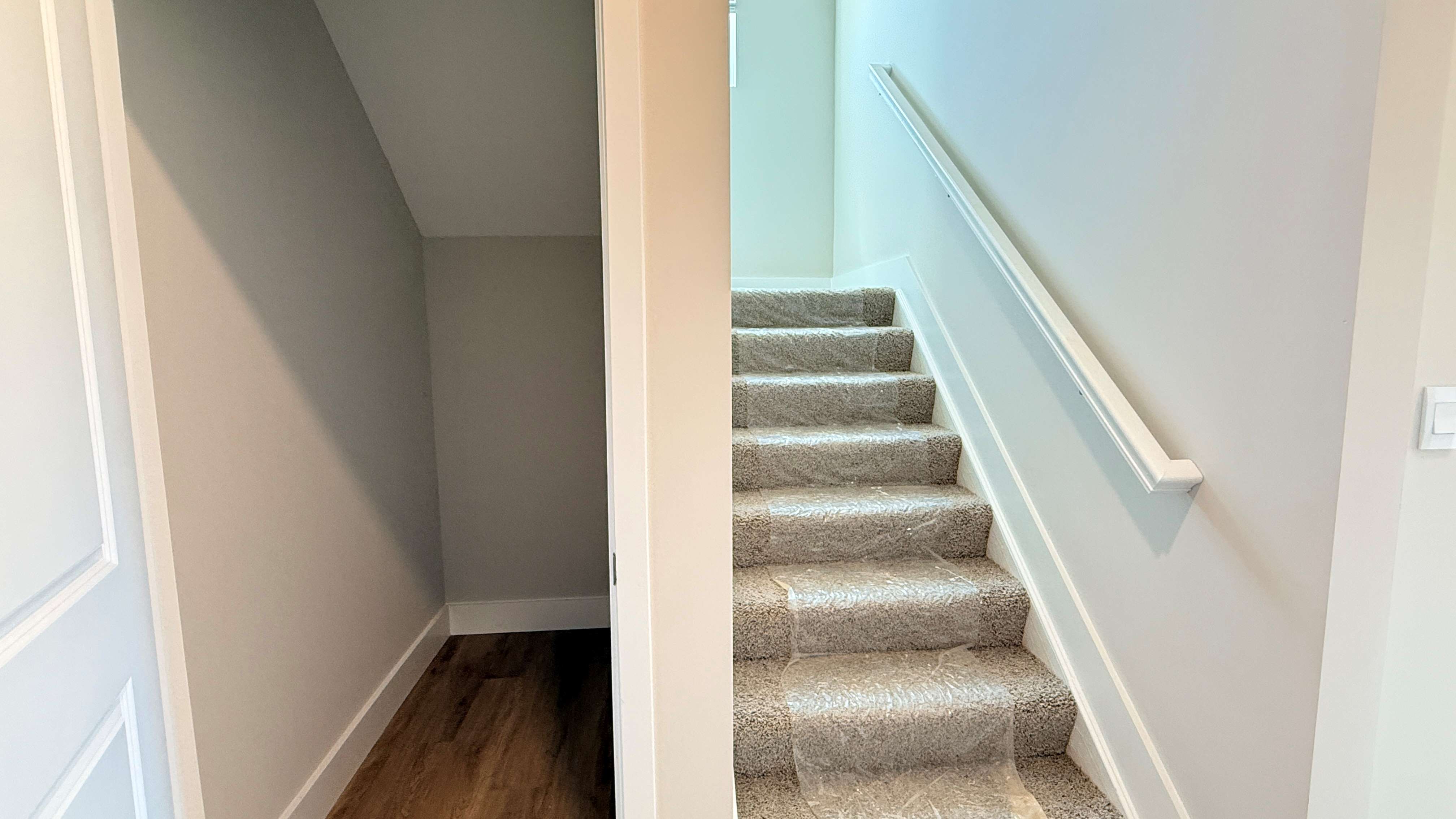 First floor closet under stairs and stairs leading to second floor.