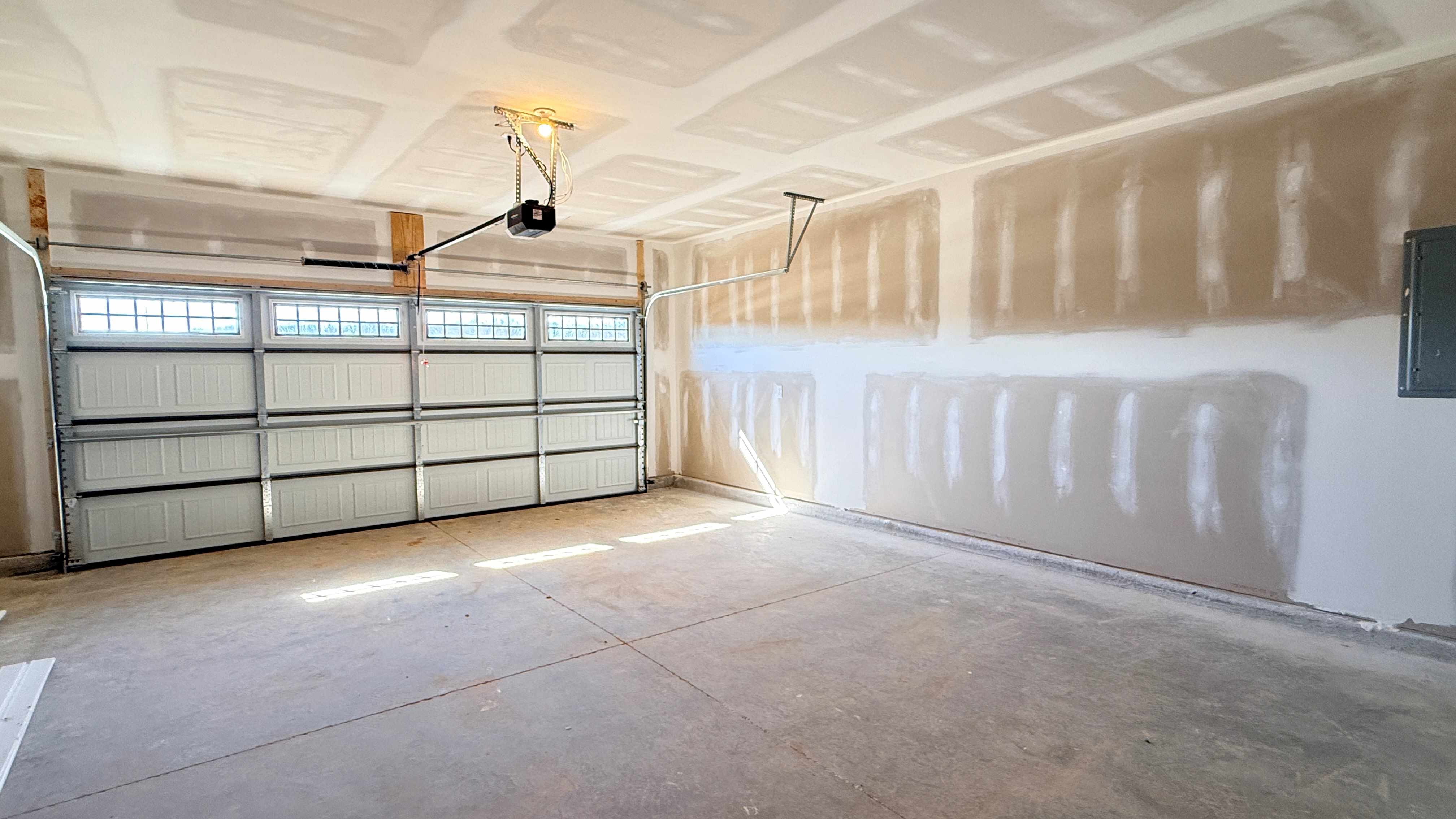 Fully drywalled garage with motor.