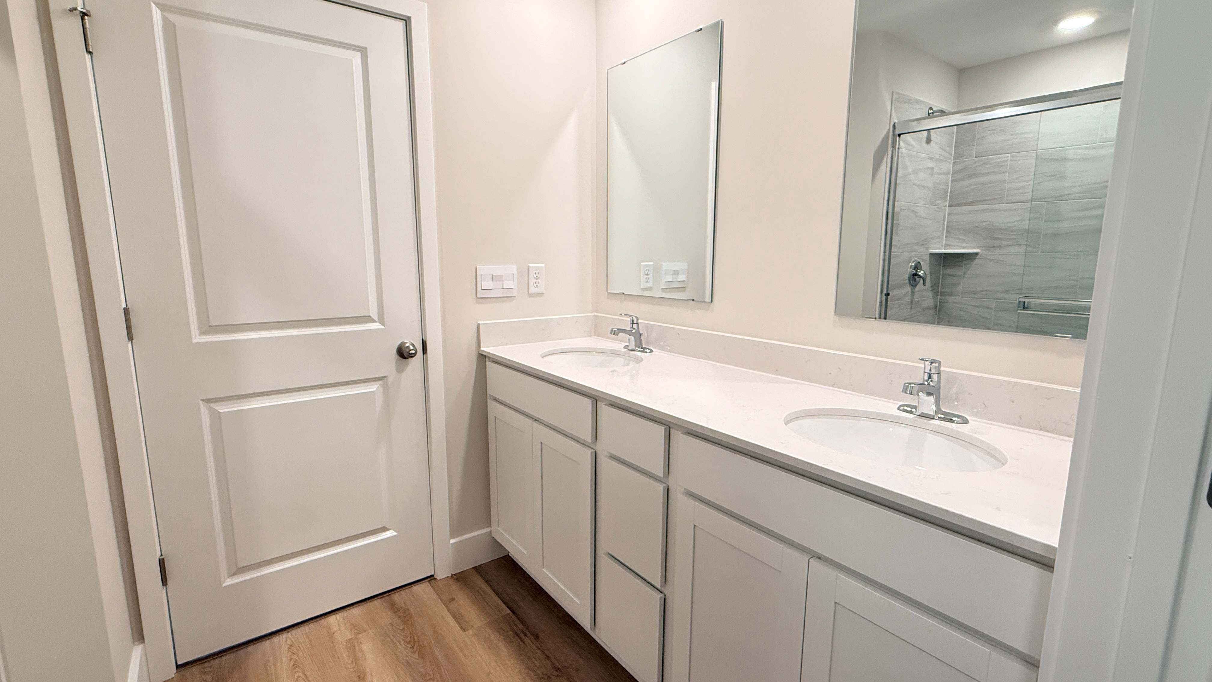 Primary bathroom with double bowl vanity.