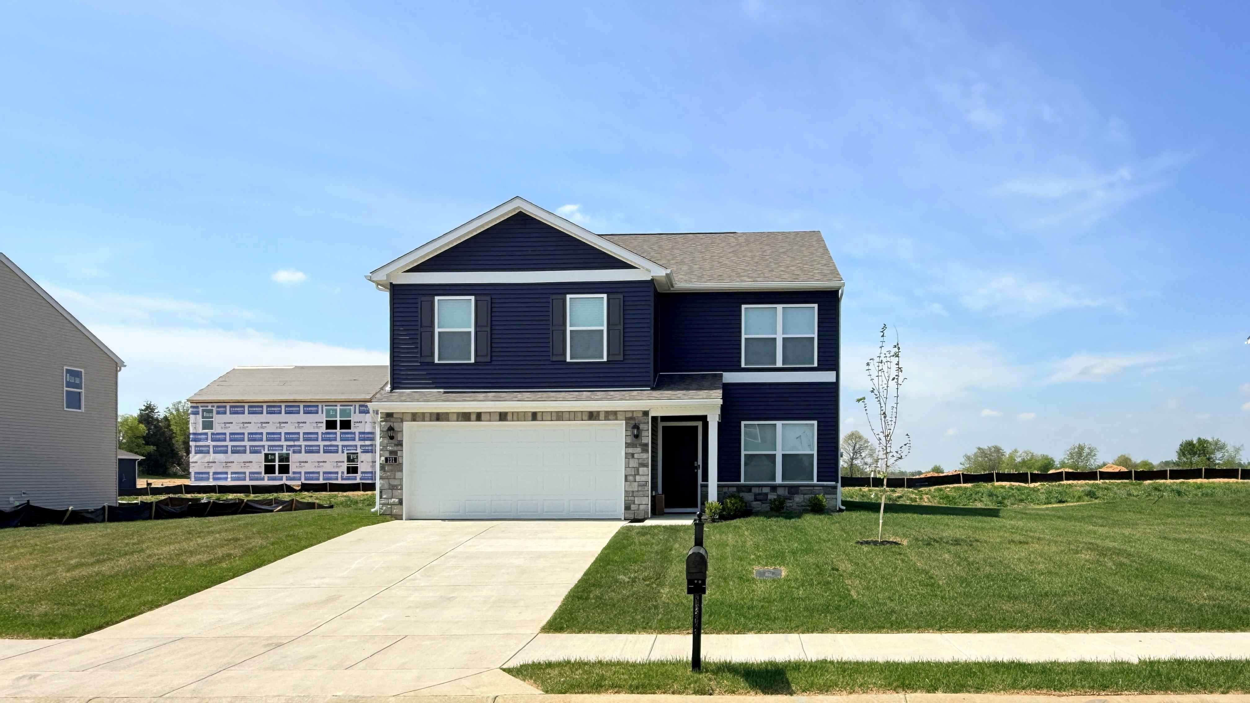 Blue bellamy floor plan with stone accents and a covered front porch.