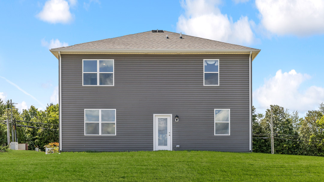 backside of home with door and 4 windows