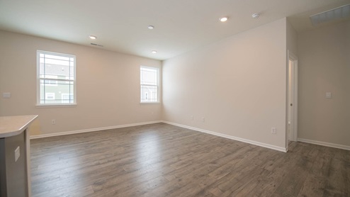 great room with two windows and laminate flooring